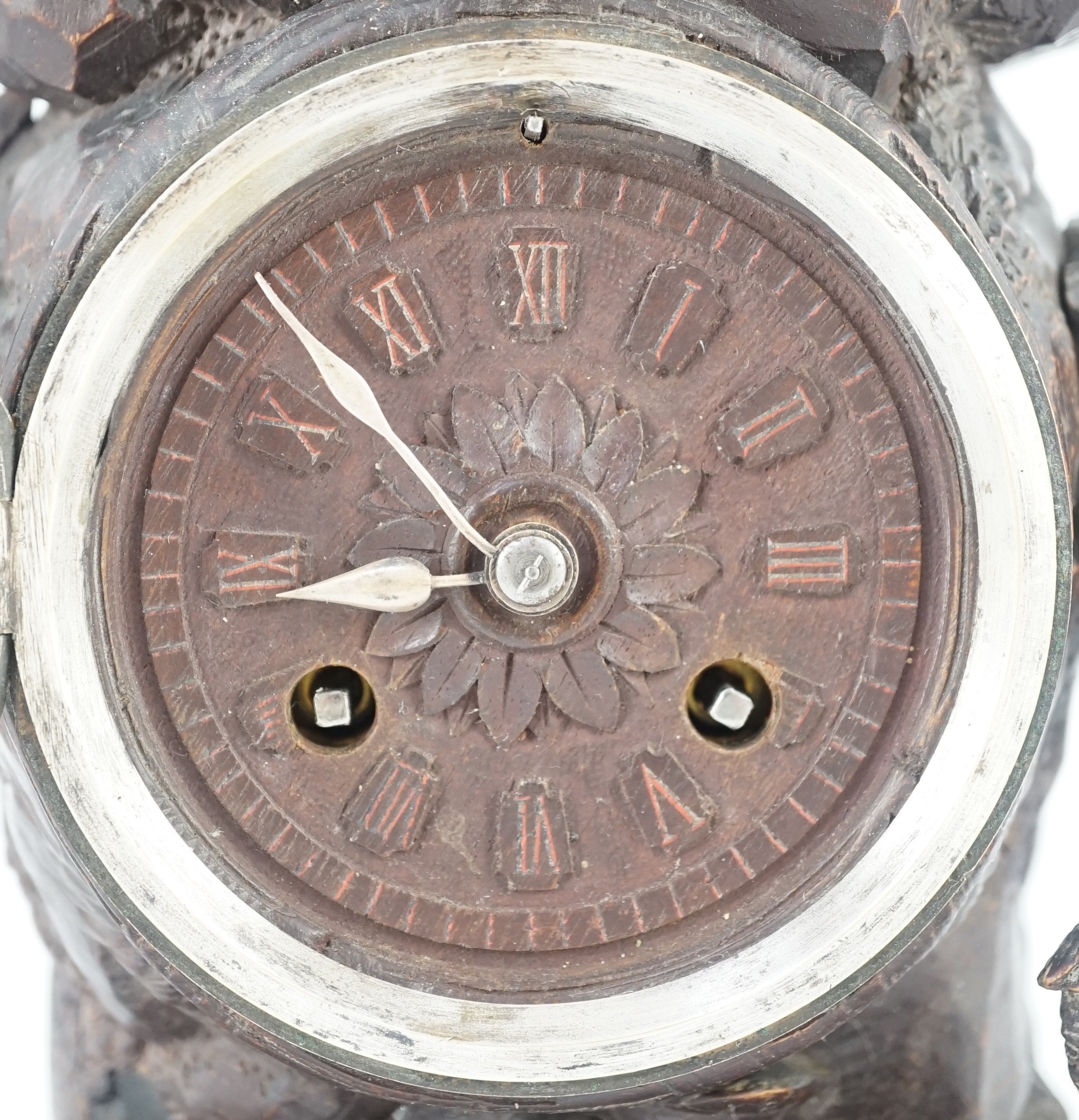 A 19th century Black Forest carved wood mantel timepiece, 30cm wide, 38cm high